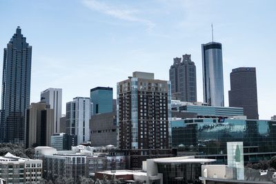 Modern buildings in city against sky