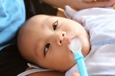 Close-up of baby boy eating food with spoon