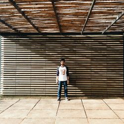 Woman standing on brick wall