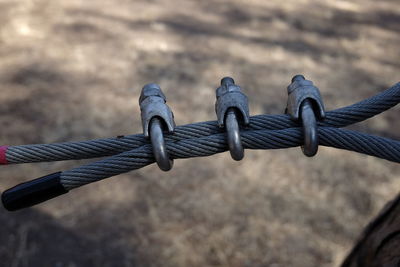 Close-up of wires locked outdoors