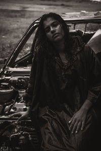 Portrait of woman grunge on broken car in rain