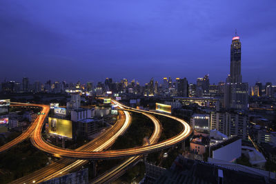 High angle view of city lit up at night