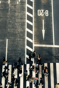 High angle view of people walking on road