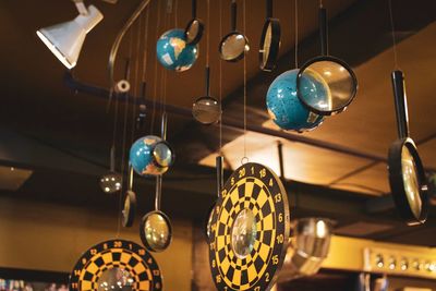 Low angle view of wind chime hanging on ceiling