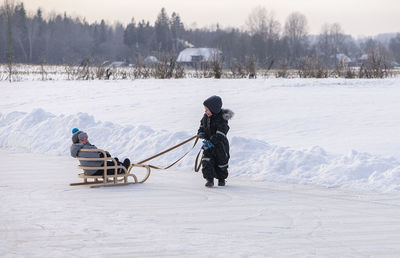 People on snowy field during winter