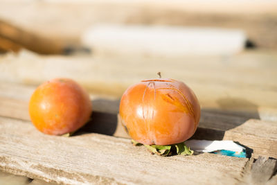 Close-up of persimmons on table