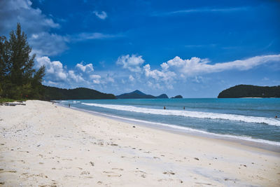 Scenic view of beach against blue sky