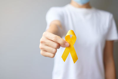 Close-up of hand holding yellow toy