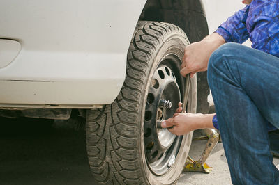 Cropped image of mechanic inflating car tire