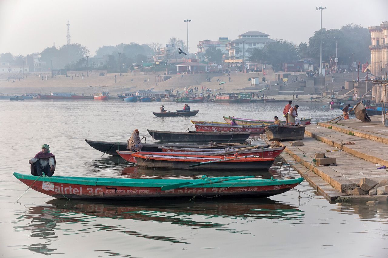 nautical vessel, transportation, mode of transport, boat, water, waterfront, moored, outdoors, men, real people, day, building exterior, nature, city, architecture, one person, sky, people