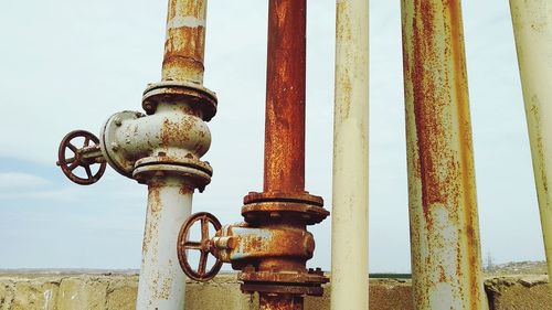 Close-up of rusty chain against sky