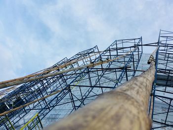 Low angle view of crane against sky