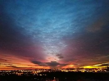 Silhouette landscape against dramatic sky at sunset