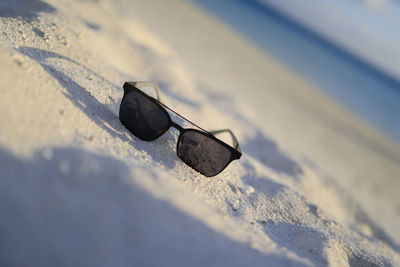 High angle view of sunglasses on beach