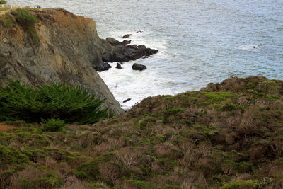 High angle view of sea by cliff