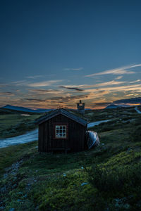 House at smuksjøseter fjellstue at sunset, blåhøe 1617 meter in horisont