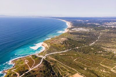 Aerial view of wild coastline with atlantic ocean waves rolling on the cliffs near praia da foz, 