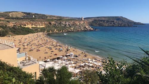 High angle view of townscape by sea against clear sky