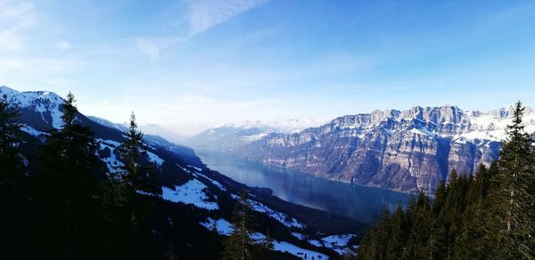 Scenic view of mountains against blue sky