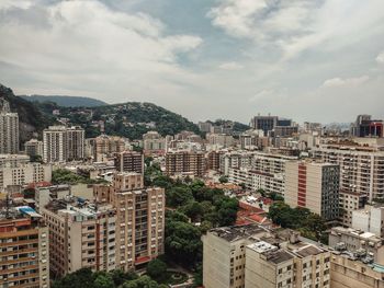 Cityscape against cloudy sky