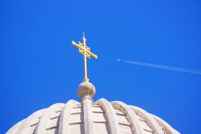 Low angle view of sculpture against clear blue sky