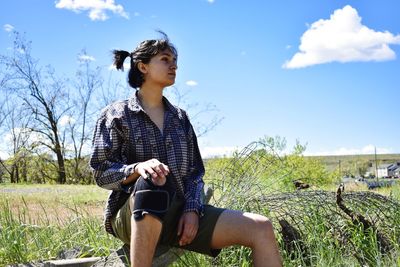 Young woman sitting on field