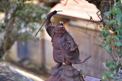 Close-up of statue against trees
