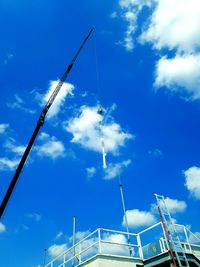 Low angle view of crane against sky