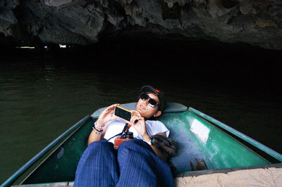 High angle view of young woman sitting on boat