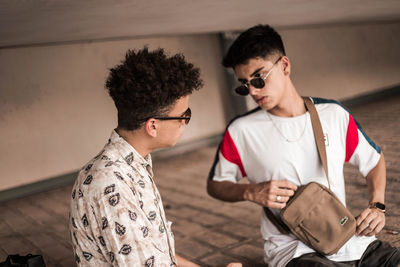 Young man and woman standing in sunglasses