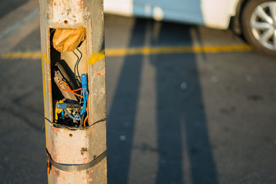 Close-up of telephone pole on road