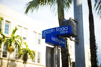 Low angle view of road sign against sky