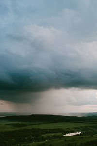 Scenic view of storm clouds over landscape