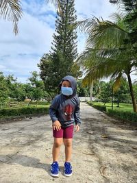 Full length of woman standing on road