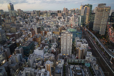 High angle view of modern buildings in city against sky