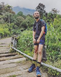 Portrait of man standing on railroad track