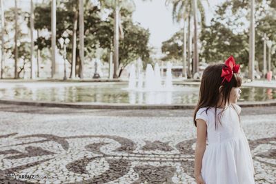 Girl standing against fountain