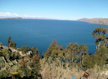 Scenic view of sea and mountains against sky