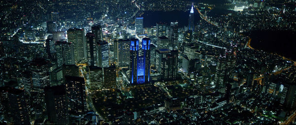 High angle view of city lit up at night