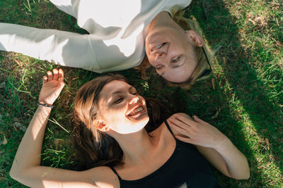 Portrait of smiling young woman sitting on grassy field