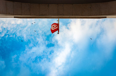 Low angle view of flag against blue sky