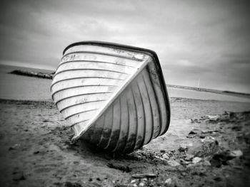 Deck chairs on beach against sky