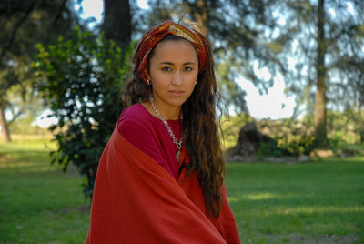 Portrait of beautiful woman standing in park