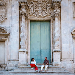 People at entrance of historic building