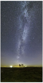 Scenic view of field against sky at night