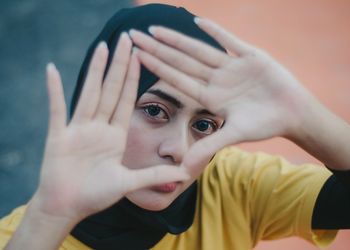 Close-up portrait of woman gesturing