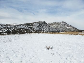 Scenic view of snowcapped mountains against sky