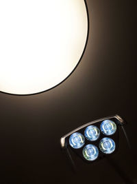 Low angle view of illuminated electric lamp