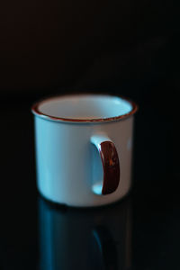 Close-up of coffee cup against black background