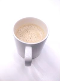 Close-up of coffee cup over white background